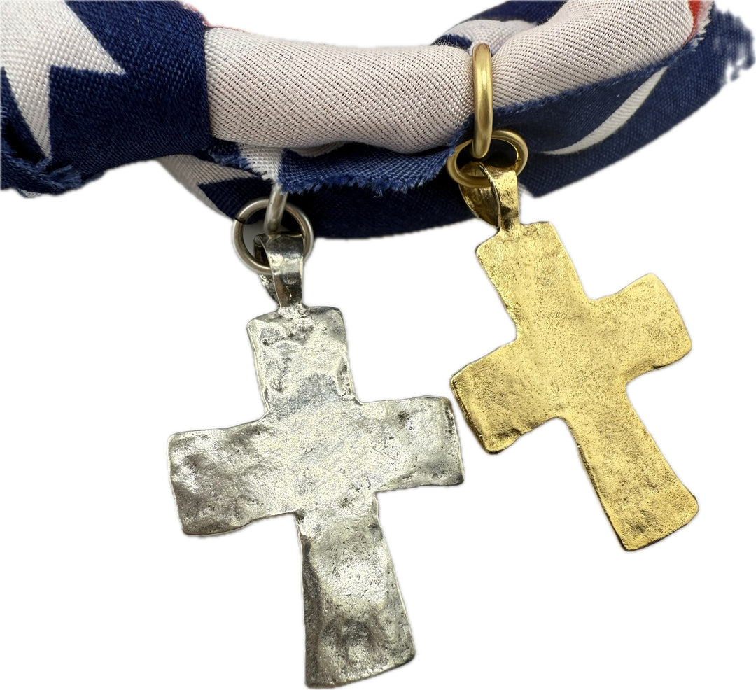 Two cross-shaped pendants, one silver and one gold, on a bandana necklace