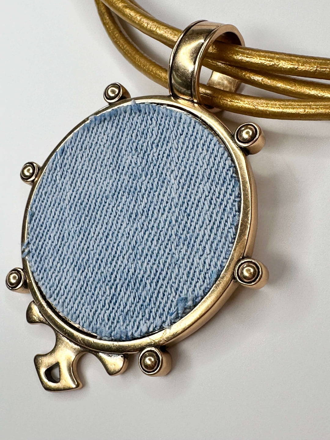 denim necklace on gold leather