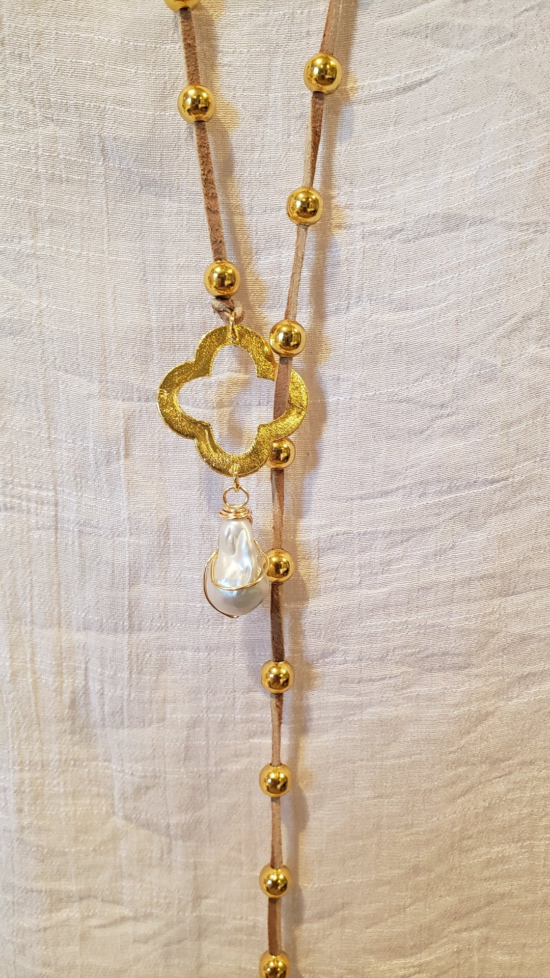 Gold Beaded Lariat With Quatrefoil Clover on Suede Leather, Beauty In Stone Jewelry at $90